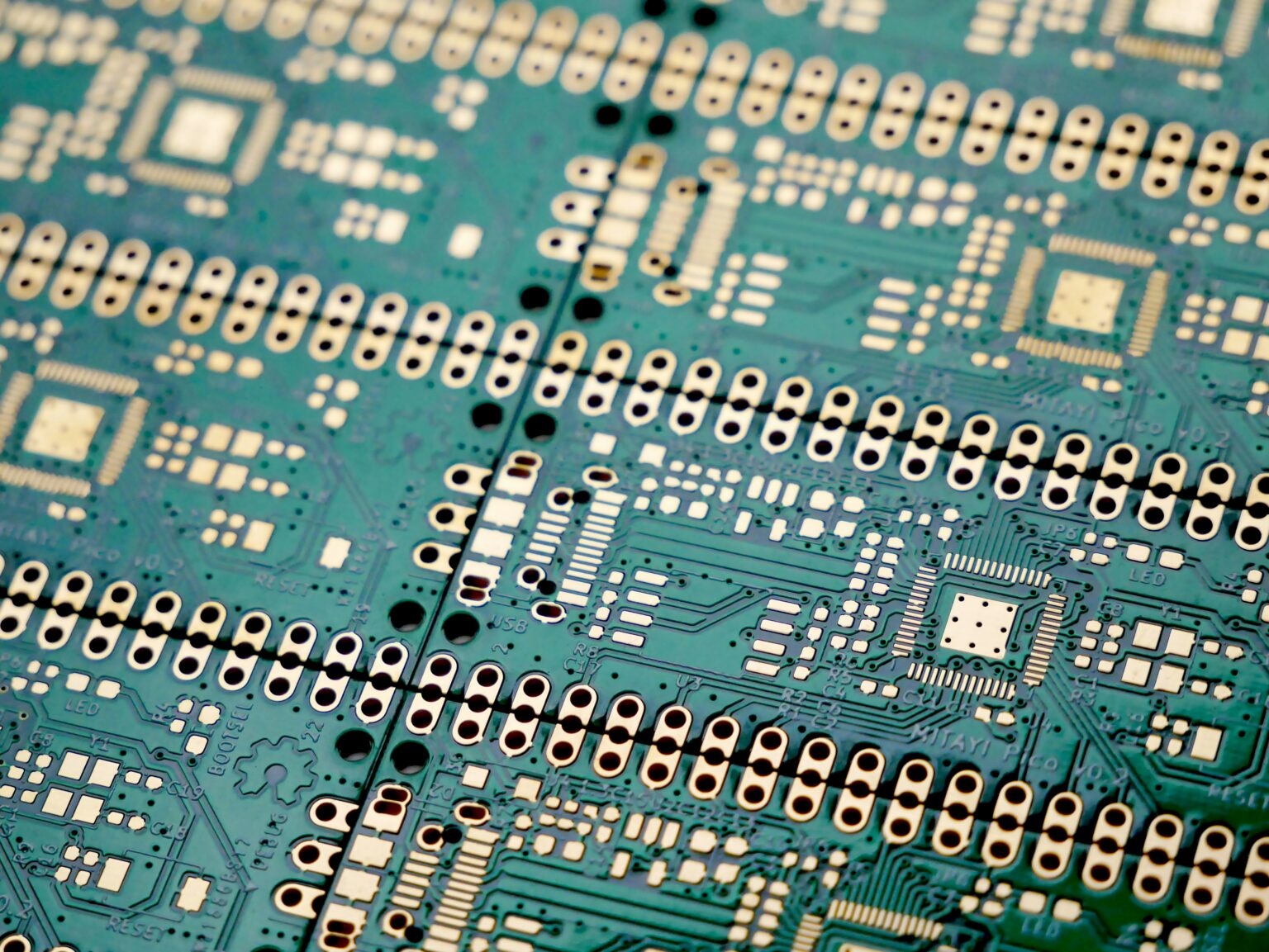 Technician assembling clean electronic components at a manufacturing workstation